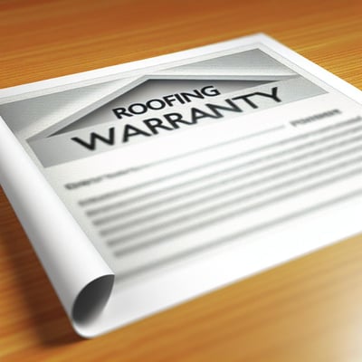 a piece of paper reading roofing warranty