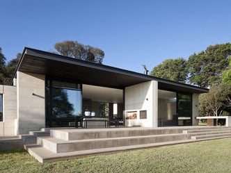 back of a modern residential home with a flat roof 