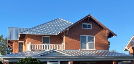 metal roof on brick home-2-1