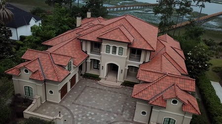 large custom home with a beautiful Spanish tile roof