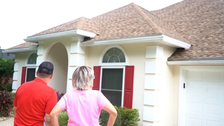 david and janet standing in front of home