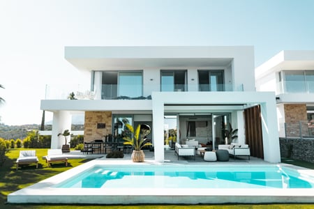 white modern-style home with backyard pool