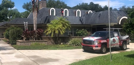 RoofCrafters truck in front of a metal shingle roof project