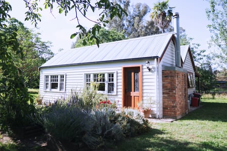 white cottage with metal roof